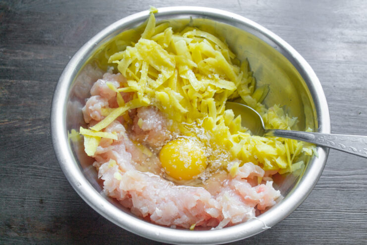 Добавление соли в фарш из курицы, картофеля и яйца