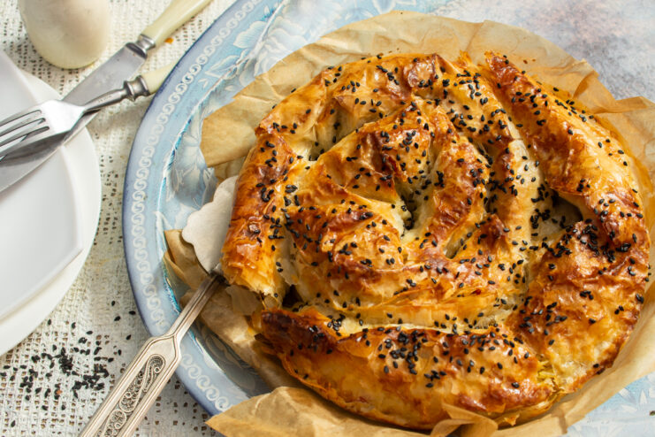 Хрустящий пирог-улитка с курицей и рисом на блюде для подачи